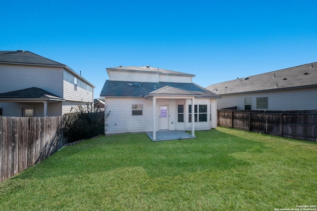 back of property with a lawn and a patio