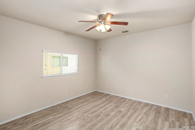 empty room featuring light hardwood / wood-style flooring and ceiling fan