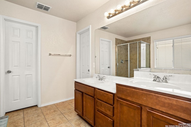 bathroom featuring vanity, tile patterned floors, and walk in shower