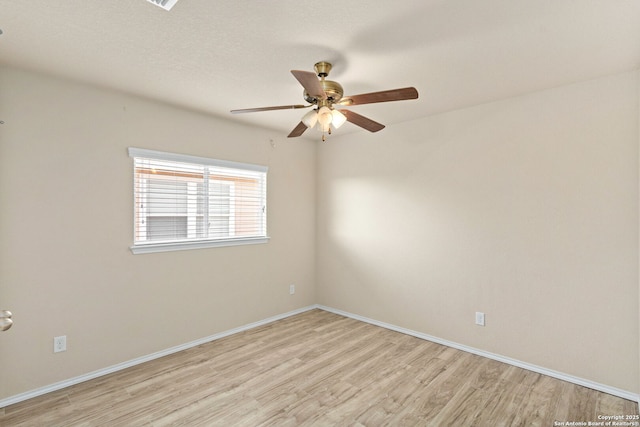 spare room featuring light hardwood / wood-style floors and ceiling fan