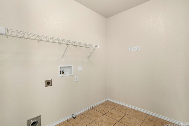 clothes washing area featuring gas dryer hookup, washer hookup, hookup for an electric dryer, and light tile patterned flooring