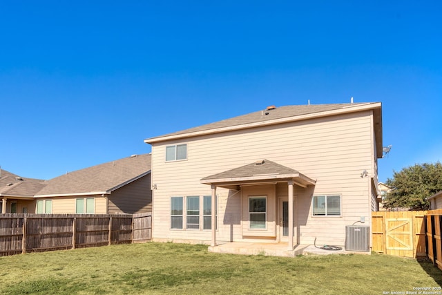 rear view of property featuring a lawn, a patio, and central air condition unit