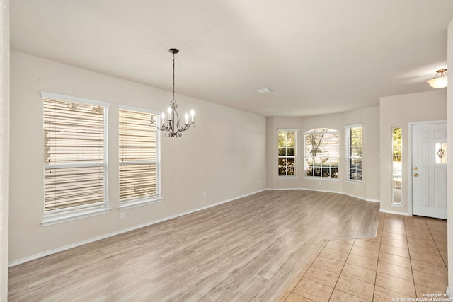 interior space with a chandelier and light hardwood / wood-style floors