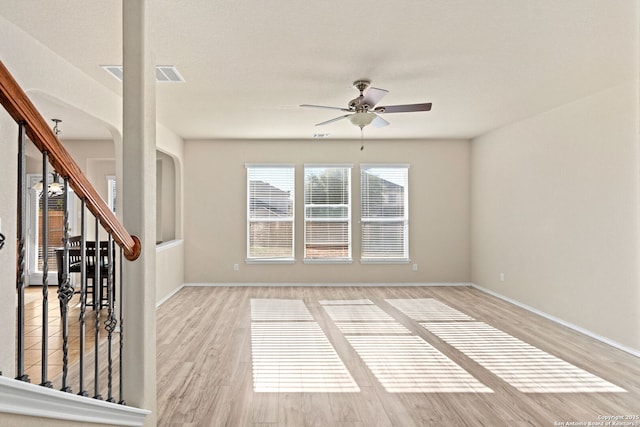 empty room featuring ceiling fan and light hardwood / wood-style floors