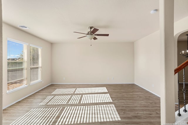 empty room with ceiling fan and wood-type flooring