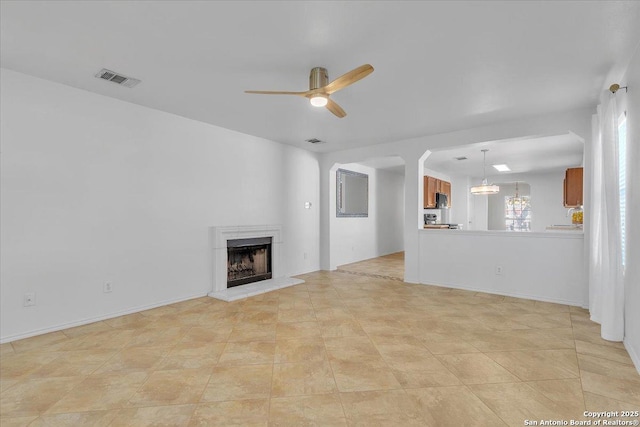 unfurnished living room with ceiling fan