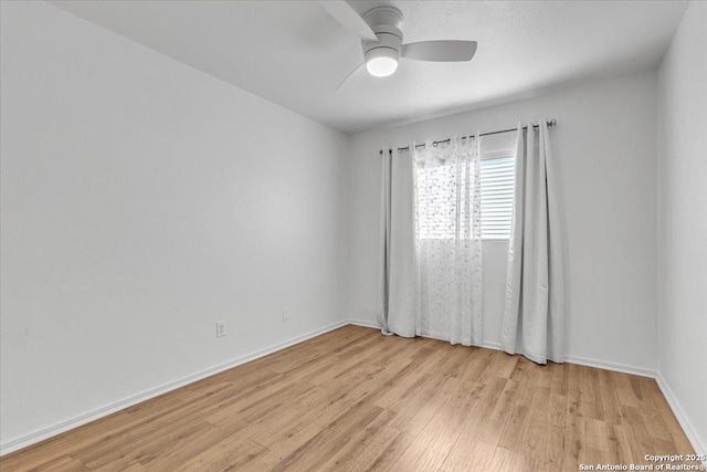 empty room featuring ceiling fan and light hardwood / wood-style flooring