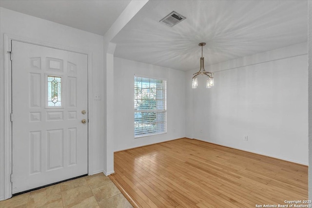 foyer with a notable chandelier