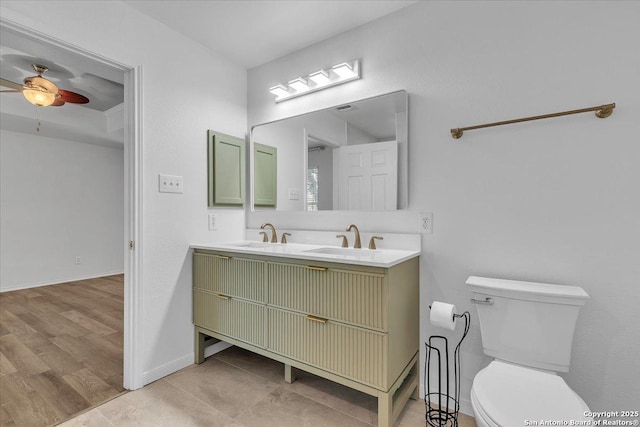 bathroom featuring vanity, ceiling fan, and toilet