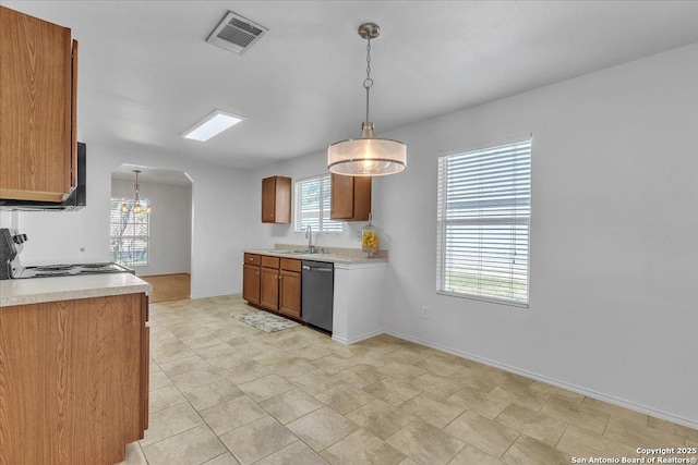 kitchen featuring pendant lighting, stainless steel dishwasher, range, and sink