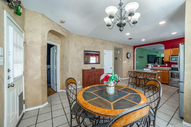 dining area with a notable chandelier and light tile patterned floors