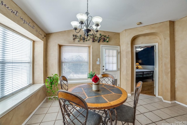 dining room with an inviting chandelier, light tile patterned floors, and plenty of natural light