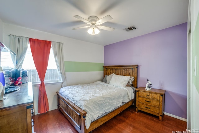 bedroom with ceiling fan and dark hardwood / wood-style flooring