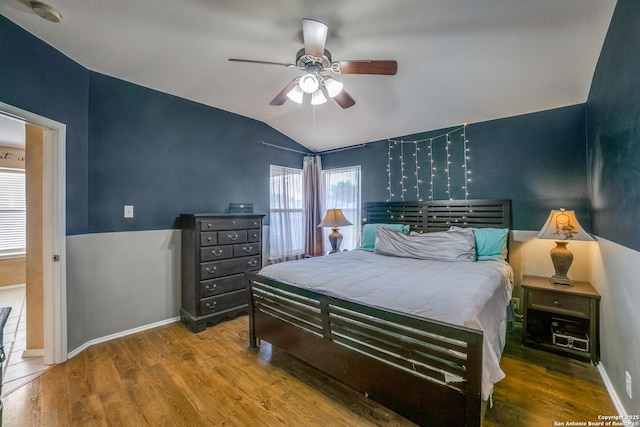 bedroom featuring lofted ceiling, hardwood / wood-style floors, and ceiling fan