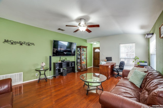 living room with wood-type flooring, vaulted ceiling, and ceiling fan