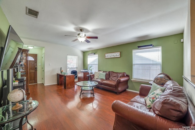 living room with dark hardwood / wood-style flooring, vaulted ceiling, and ceiling fan