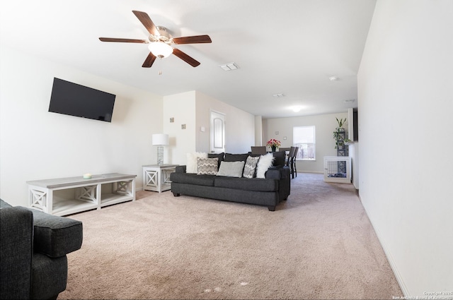 living room with light colored carpet and ceiling fan