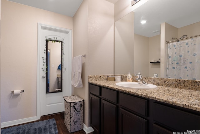 bathroom featuring vanity, hardwood / wood-style floors, and walk in shower