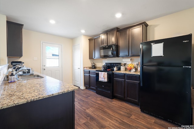 kitchen featuring sink, dark brown cabinets, black appliances, and dark hardwood / wood-style floors