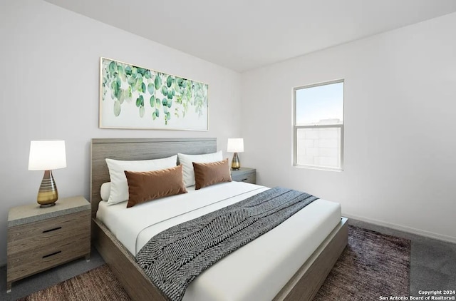 bedroom with dark colored carpet