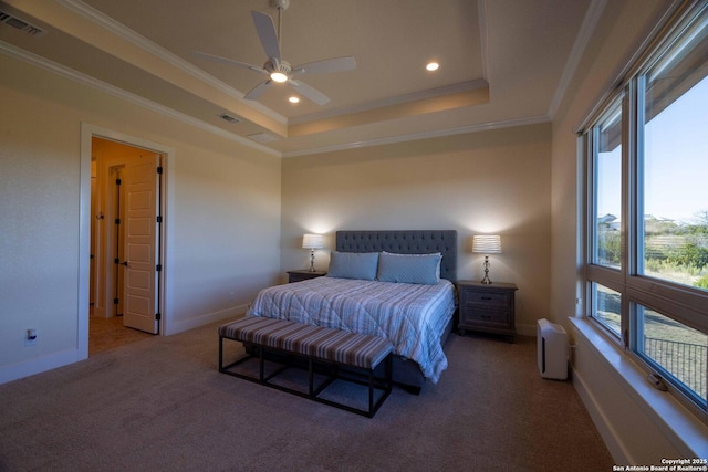 bedroom with a tray ceiling, ornamental molding, ceiling fan, and carpet flooring