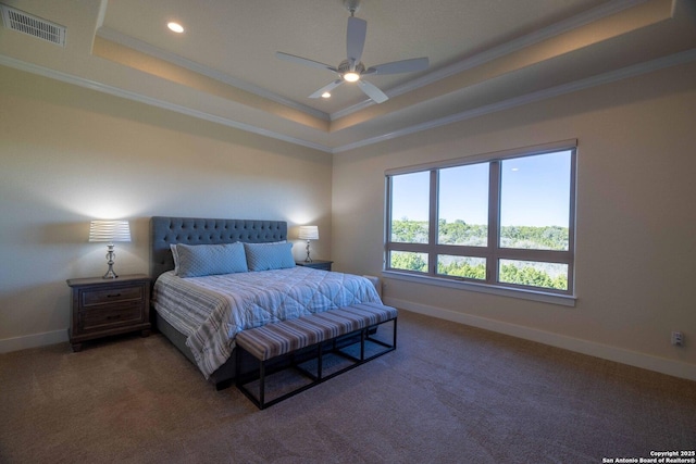 carpeted bedroom featuring crown molding, a tray ceiling, and ceiling fan