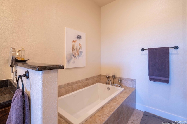 bathroom featuring a relaxing tiled tub and tile patterned flooring