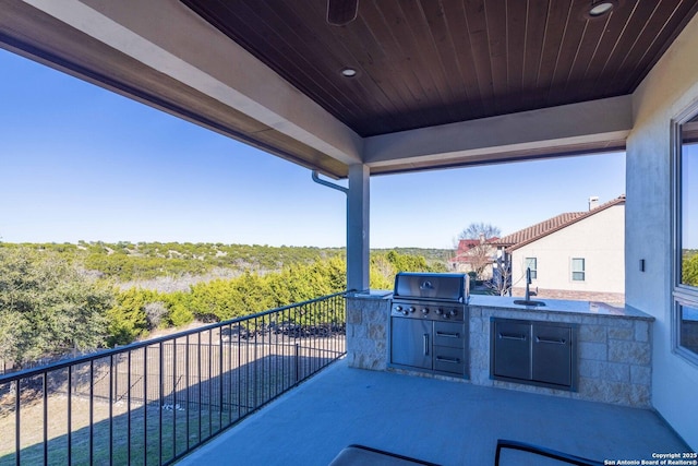 view of patio / terrace featuring area for grilling, a grill, sink, and a balcony