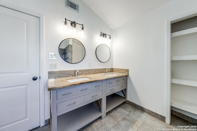 bathroom featuring lofted ceiling and vanity