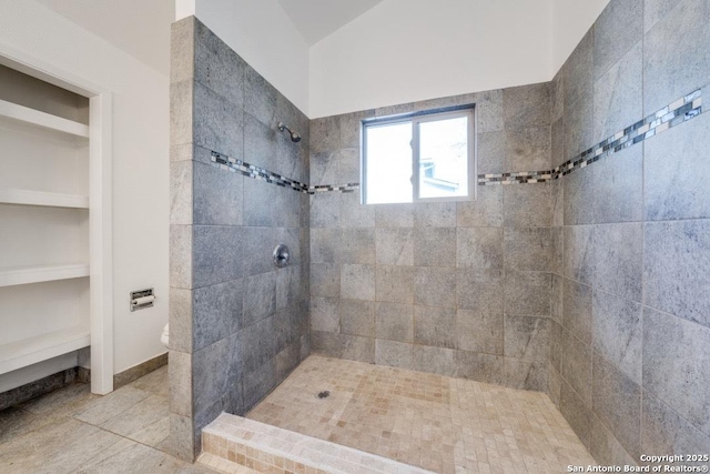 bathroom with a tile shower