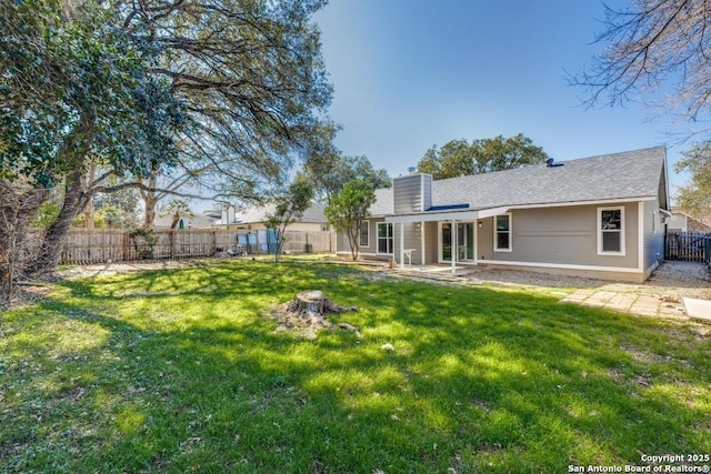 back of property featuring a lawn and a patio area