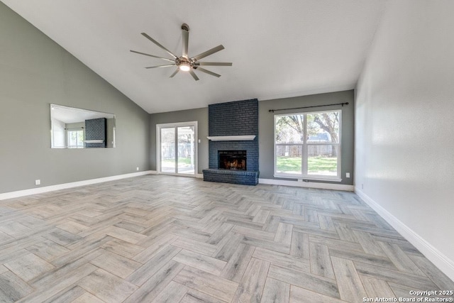 unfurnished living room featuring a brick fireplace, a wealth of natural light, and light parquet flooring