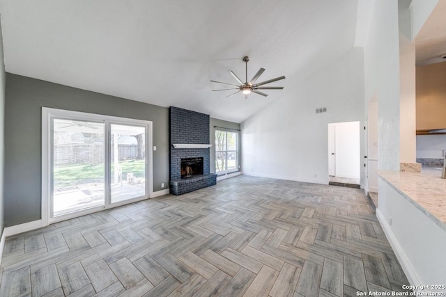 unfurnished living room with ceiling fan, a fireplace, high vaulted ceiling, and light parquet floors