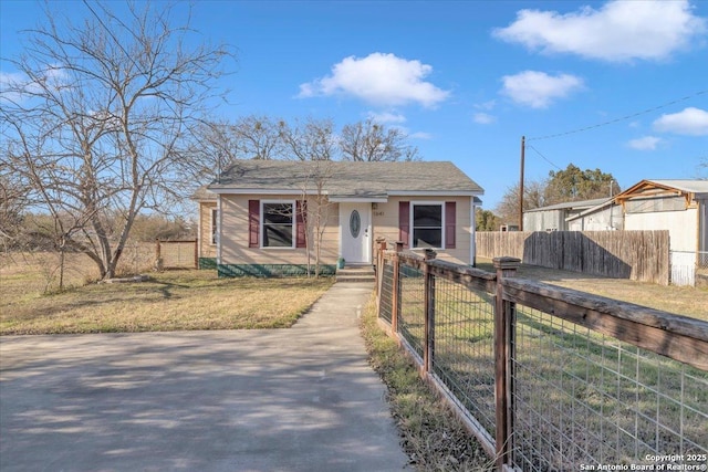 bungalow-style home with a front yard