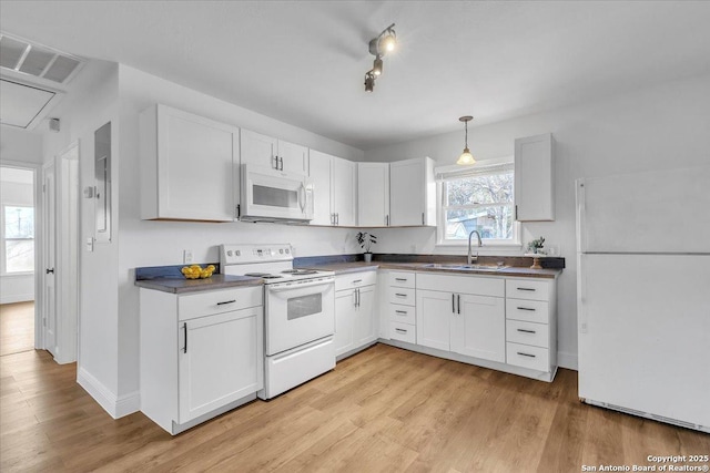1641 Post Rd, New Braunfels, TX 78130 - kitchen with white appliances, a wealth of natural light, sink, and white cabinets