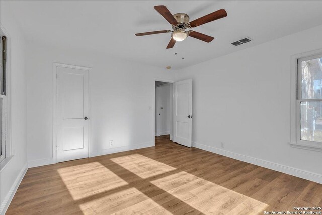 1641 Post Rd, New Braunfels, TX 78130 - unfurnished bedroom featuring ceiling fan and light hardwood / wood-style flooring
