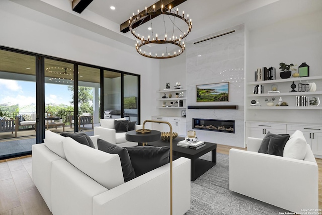 living room with a premium fireplace, beamed ceiling, and light wood-type flooring