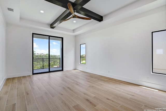 spare room featuring ceiling fan, beam ceiling, and light hardwood / wood-style floors