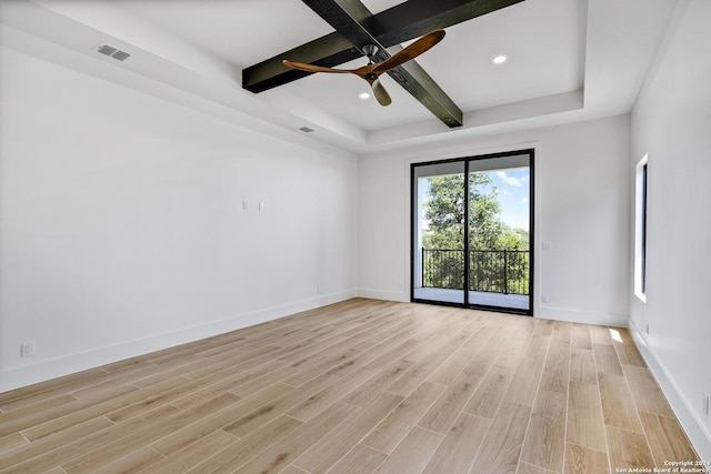 spare room with beamed ceiling, ceiling fan, and light wood-type flooring