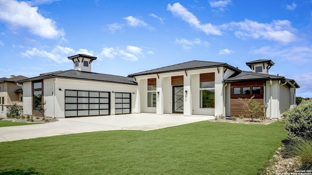 view of front of property with a garage and a front lawn