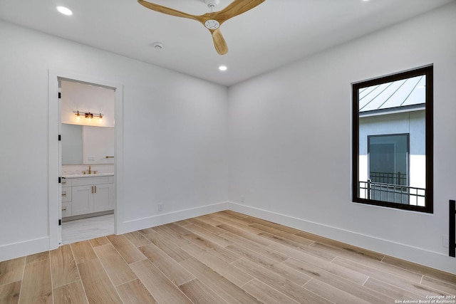 unfurnished room with ceiling fan, sink, and light hardwood / wood-style flooring