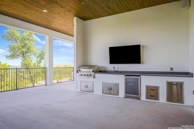 view of patio / terrace featuring an outdoor kitchen, grilling area, sink, and wine cooler