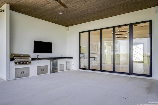 unfurnished living room with concrete flooring, sink, wooden ceiling, and beverage cooler