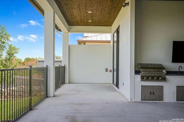 balcony with grilling area, exterior kitchen, and sink