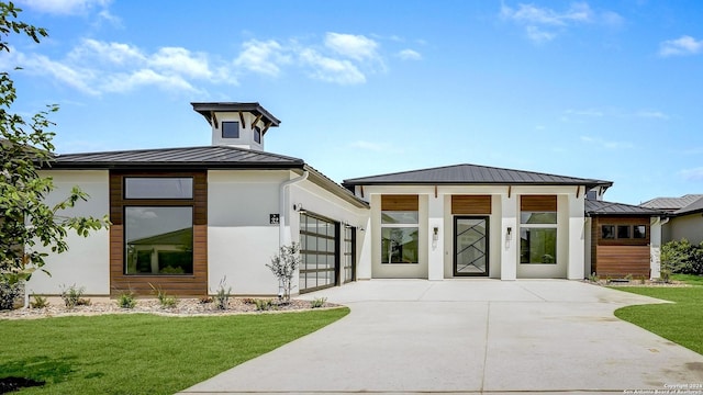 view of front of home featuring a garage and a front lawn