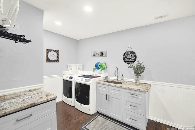 washroom with separate washer and dryer, sink, dark wood-type flooring, and cabinets