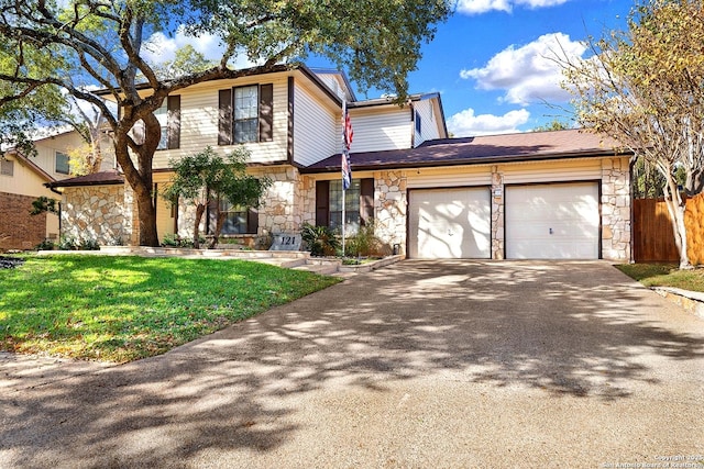 view of property with a garage and a front lawn