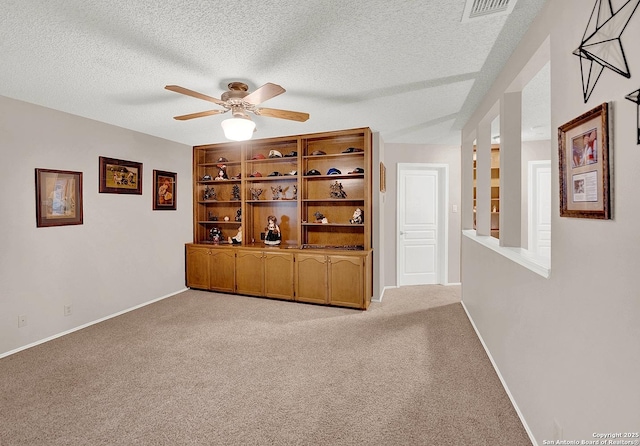 interior space featuring ceiling fan and a textured ceiling