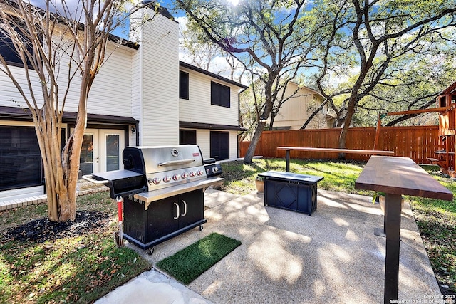 view of patio / terrace featuring french doors, a grill, and an outdoor fire pit