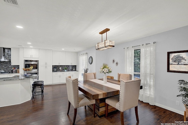 dining area featuring dark wood-type flooring